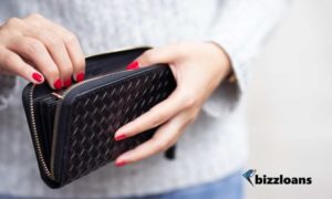 woman holding empty wallet